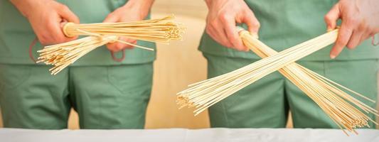 Bamboo massage brooms in hands photo