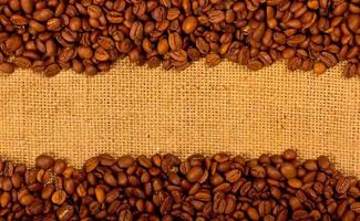 Coffee grains on the burlap background photo