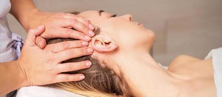 Young woman receiving head massage photo