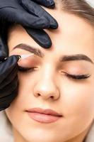 Permanent makeup on female eyebrows photo