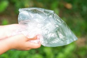 Plastic bag in little hands photo