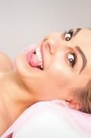 Young woman sticking out tongue photo