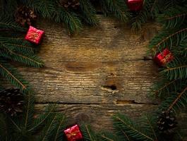 Christmas tree branches with christmas decorations on wooden texture photo