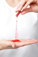 Manicurist pours red pigment nail powder photo