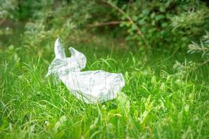 Plastic bags lying on grass photo