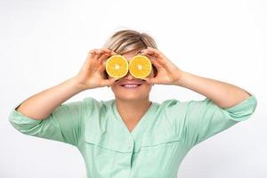 Cosmetologist covering eyes with orange photo