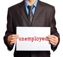 A man with a sign that says unemployed photo