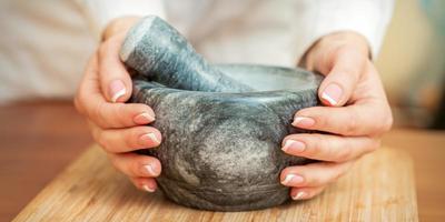 Mortar and pestle in hands photo