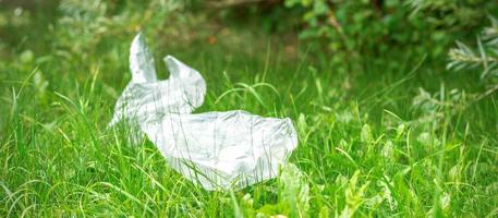 Plastic bags lying on grass photo