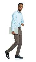 Happy african american college student with laptop standing on white photo