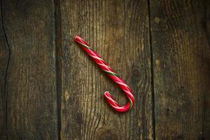 Christmas candy cane on a wooden background photo