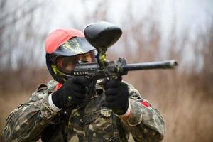 Paintball sport player wearing protective mask photo