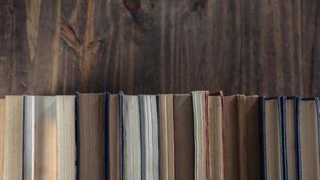 Stack of books over wooden table photo