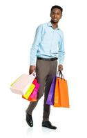 African american man holding shopping bags on white background. Shopping photo