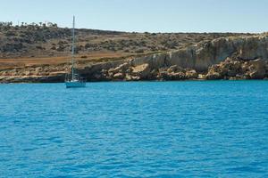 Boat in the blue lagoon, Cyprus photo