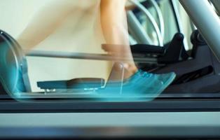 Foot of woman running on treadmill photo