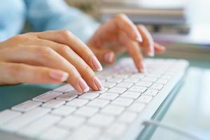 Woman office worker typing on the keyboard photo