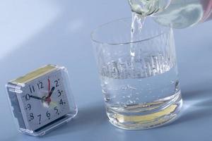Detail of person filling glass of water. hydration concept photo
