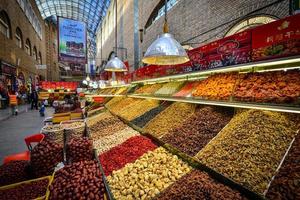 Variety of brightly colored and nutritious locally produced dried fruits and nuts at the New Grand Bazaar in China photo