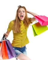 Emotional lovely woman with shopping bags over white photo