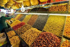 Variety of brightly colored and nutritious locally produced dried fruits and nuts at the New Grand Bazaar in China photo