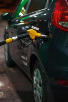 coche repostaje en un gasolina estación en invierno a noche foto