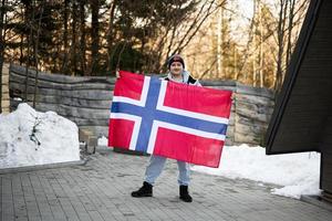 Portrait of man holding Norway flag. Scandinavian culture, norwegian people. photo