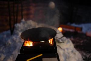 Wood fired barbecue with brgiht burning flame at evening time. photo