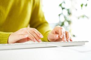 Woman office worker typing on the keyboard photo