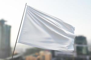 White flag mockup on the blue sky background. photo