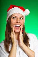 Cheerful girl in a Christmas hat photo