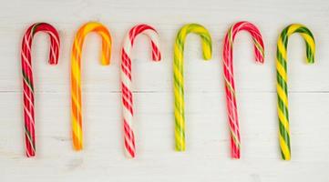 Christmas candy cane on a wooden background photo