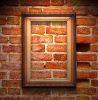The wood frame on brown brick wall photo