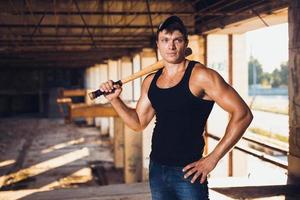 Muscular man with baseball bat photo