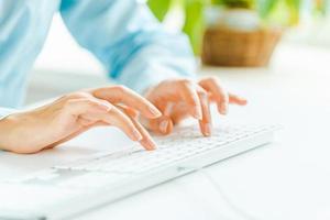 Woman office worker typing on the keyboard photo