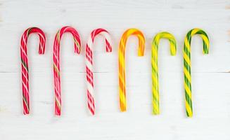 Christmas candy cane on a wooden background photo