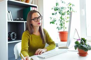 Young woman working from home - modern business concept photo