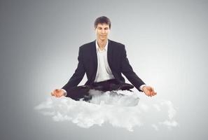 Businessman sitting on a cloud photo