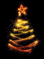 Christmas tree made by sparkler on a black photo