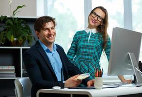 Young colleague - man and woman working from home - modern business concept photo
