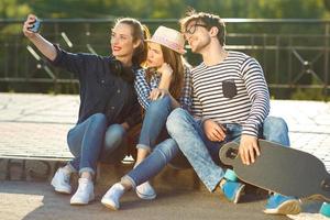 Smiling friends making selfie outdoors photo