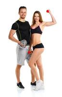 Sport couple - man and woman with dumbbells on the white photo