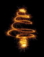 Christmas tree made by sparkler on a black photo