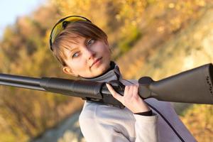 Young beautiful girl with a shotgun photo