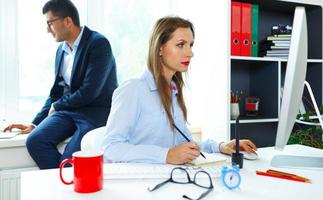 Beautiful young woman and man working from home photo