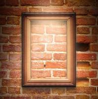 The wood frame on brown brick wall photo