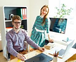 Young woman and man working from home - modern business concept photo