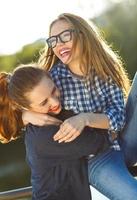 Two playful young women having fun outdoors photo