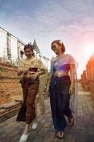 two asian woman wearing old thai tradition suit walking in ayutthaya temple one of world heritage site of unesco in thailand photo