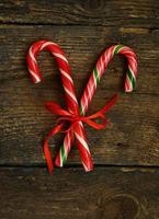 Closeup of two old fashioned candy canes on a rustic wooden background photo